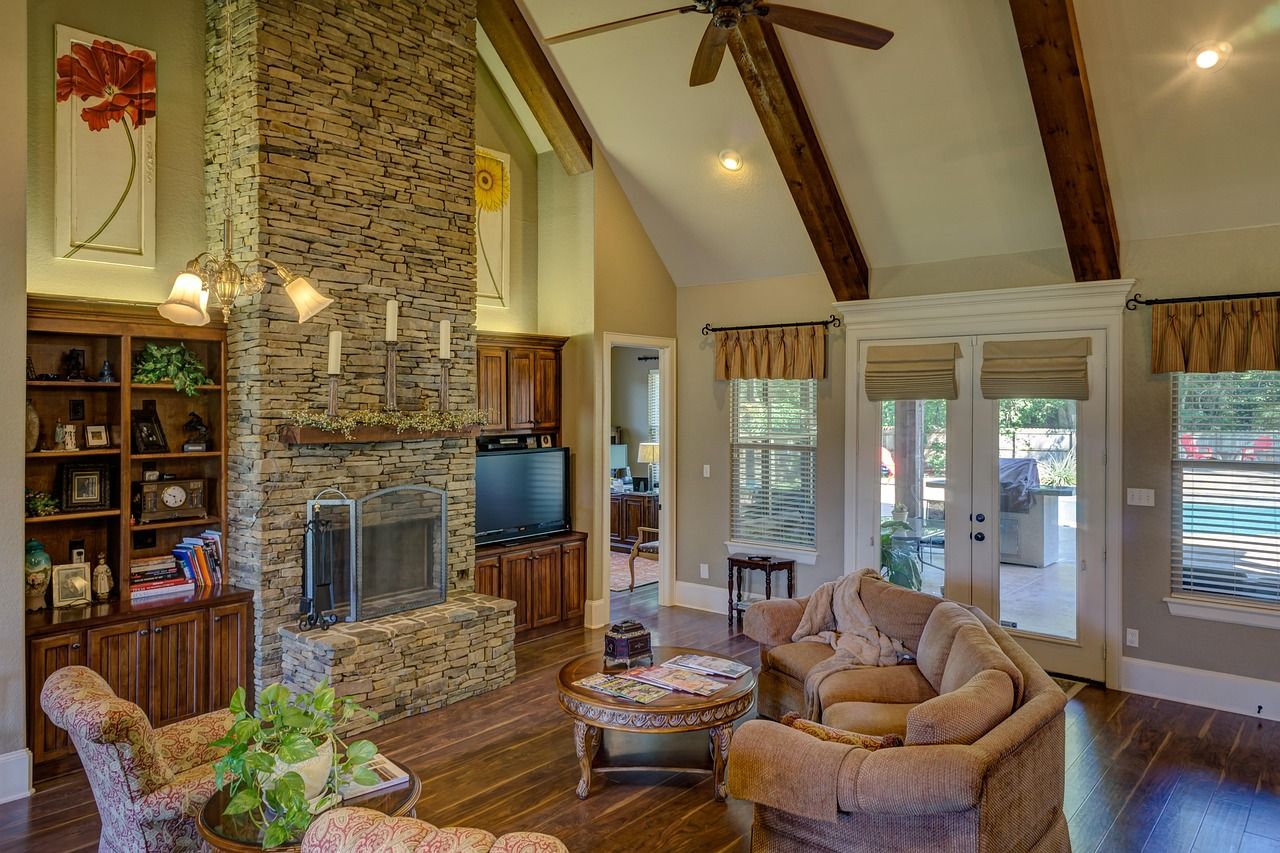 Wide-plank hardwood floor in a Texas-style living room with brick fireplace